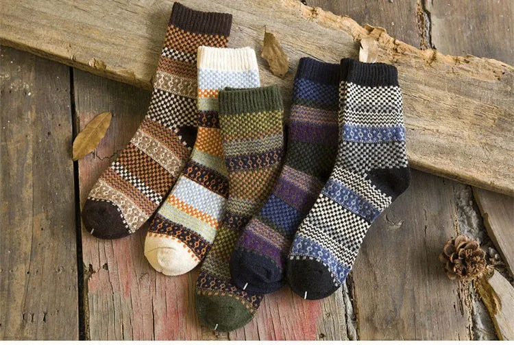 erinevates mustrites ja värvides meeste villased sokid puidust taustal