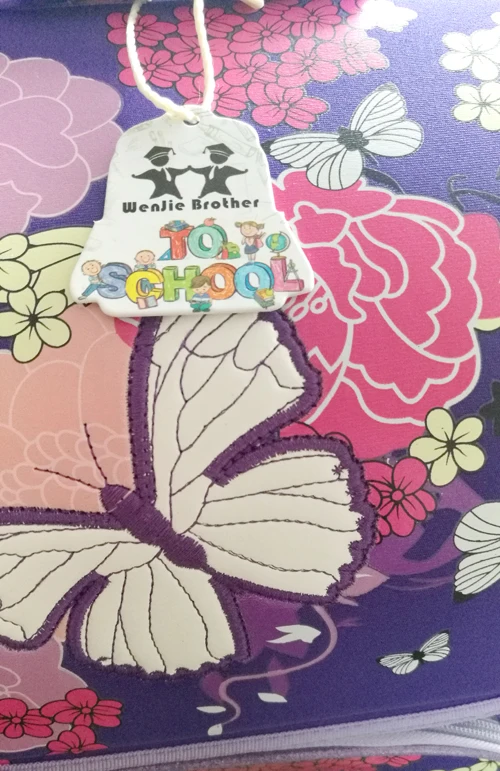 laste koolikott liblikate ja lilledega, lilla ja roosa tooniga