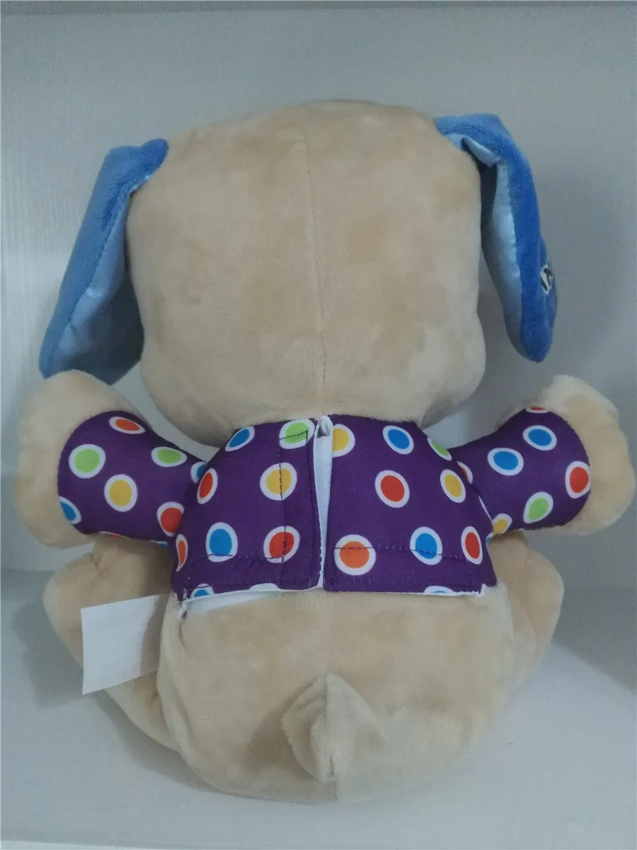 beež pehme koer, millel on sinised kõrvad ja värviliste täppidega lilla vest