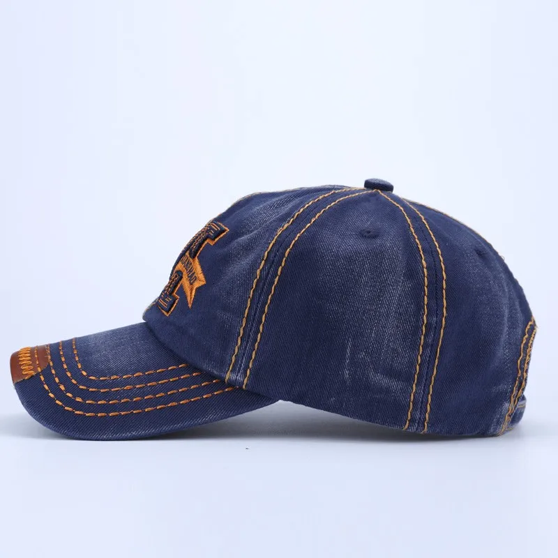 tumesinine puuvillane nokkmüts oranžide õmblustega