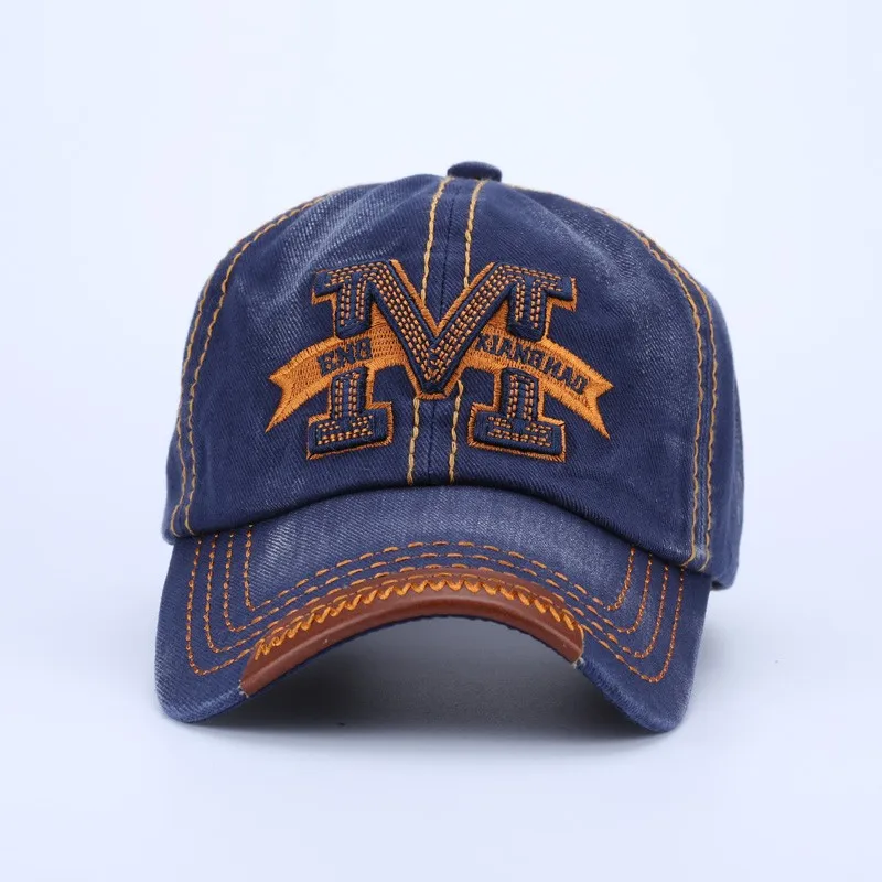 tumesinine puuvillane nokkmüts oranži tikandiga