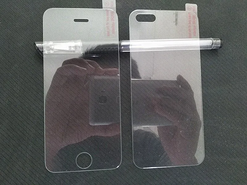 kaks läbipaistvat ekraanikaitset iPhone 5/5S jaoks mustal taustal