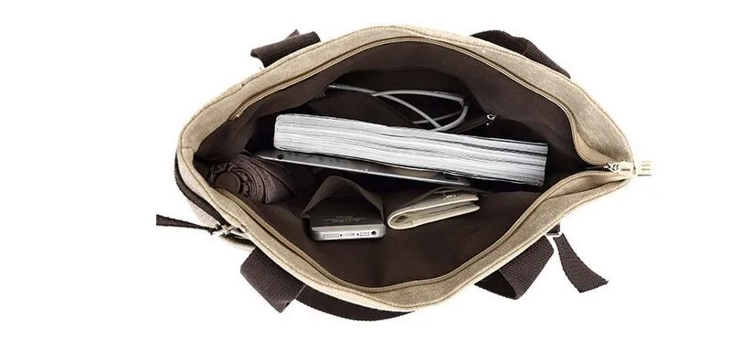 avatud õlakott, mille sees on raamat, rahakott, telefon ja juhtmed