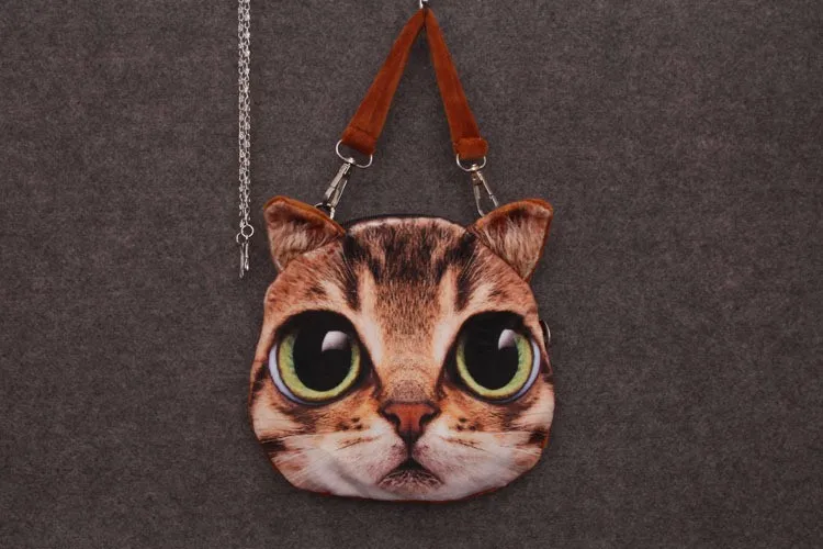 ümar õlakott suure kassi näoga, millel on suured rohelised silmad ja pruunid kõrvad