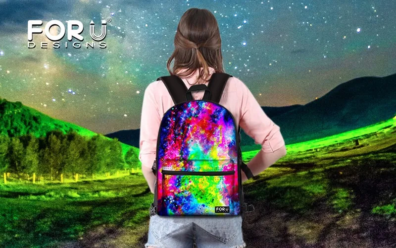 naine seljas värvikas 3D loomapiltidega seljakott öises maastikus